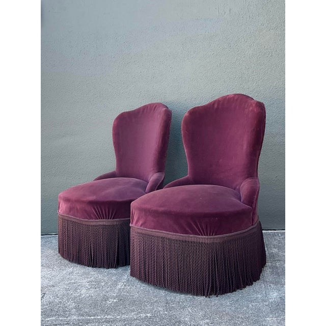 This exquisite pair of vintage slipper chairs captures the playful glamour of Hollywood Regency design with a touch of...