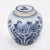 A beautifully rounded blue and white porcelain jar hand-painted with blooming chrysanthemums and leafy branches,...