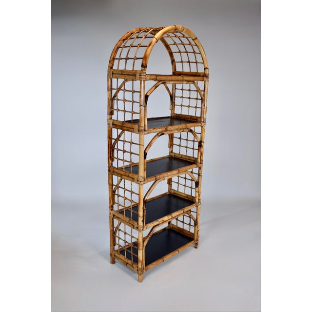 A substantial 1960's vintage British Colonial style hand crafted bamboo étagère showcasing five wooden shelves, classic...