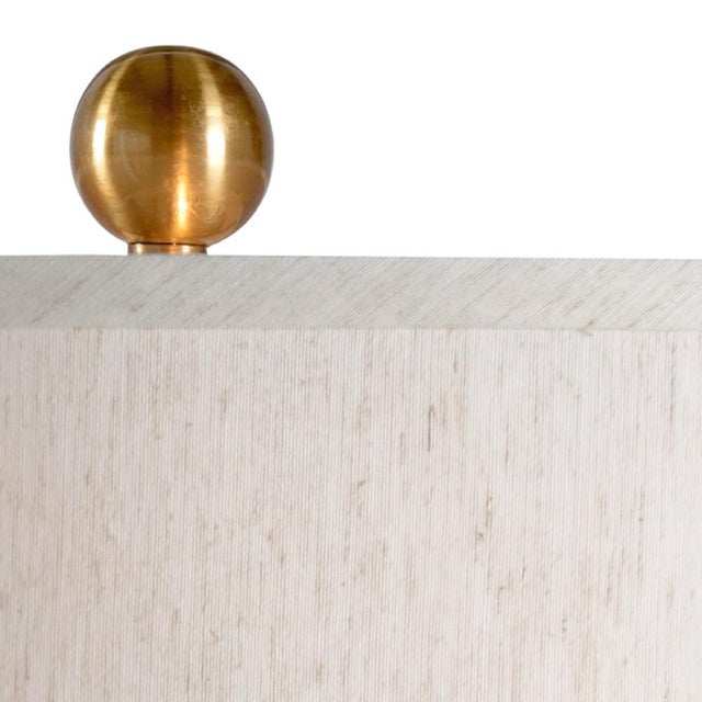 Adele lamp is an elegant natural white alabaster and brass 32" table lamp.Its gracefully curved hourglass silhouette is...