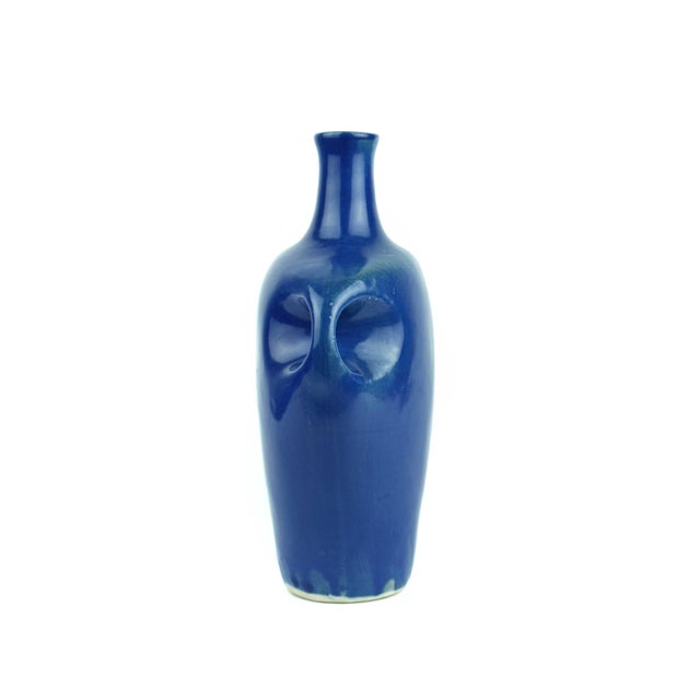 This striking Mid-Century Modern studio pottery vase features a bold, sculptural silhouette finished in a vibrant, deep...