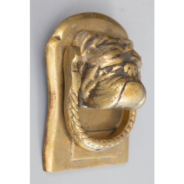 A fine antique 19th Century English brass bulldog door knocker. From a superb collector's estate in England. This charming...