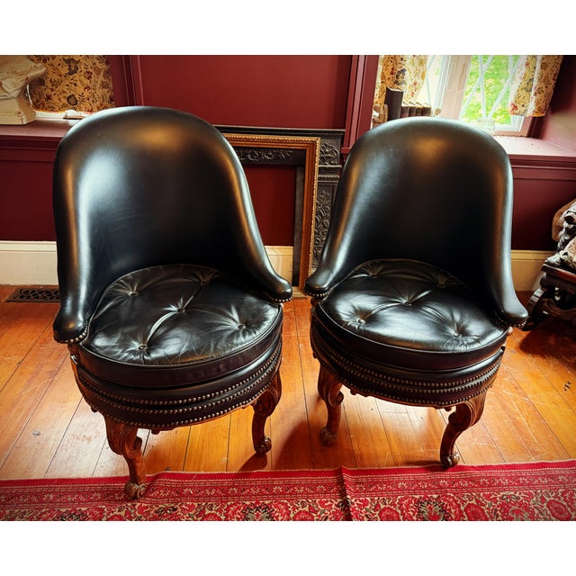 Pair of Maitland-Smith 4330-810 Black Leather Swivel Chairs A striking matching pair of Maitland-Smith Model 4330-810...
