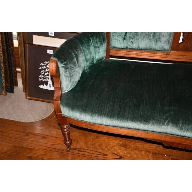 A handsome 19th-century Eastlake Victorian chair, upholstered in a rich forest-green velvet. Crafted from solid...
