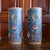 A beautiful pair of polychrome porcelain cylinders, with bright enameled zoomorphic and foliate decoration in orange,...