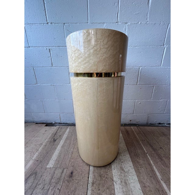 A sophisticated Postmodern cylindrical pedestal or covered vessel clad in cream-colored goatskin and accented with a...