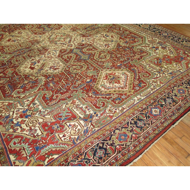 An early 20th century Persian Heriz rug Full Pile Condition featuring a dramatic medallion and large-scale design....