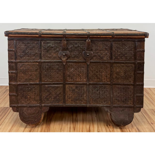 Large vintage Indian wedding trunk on wheels. Features strong wood, incredible metal hardware, and fine detail work. This...