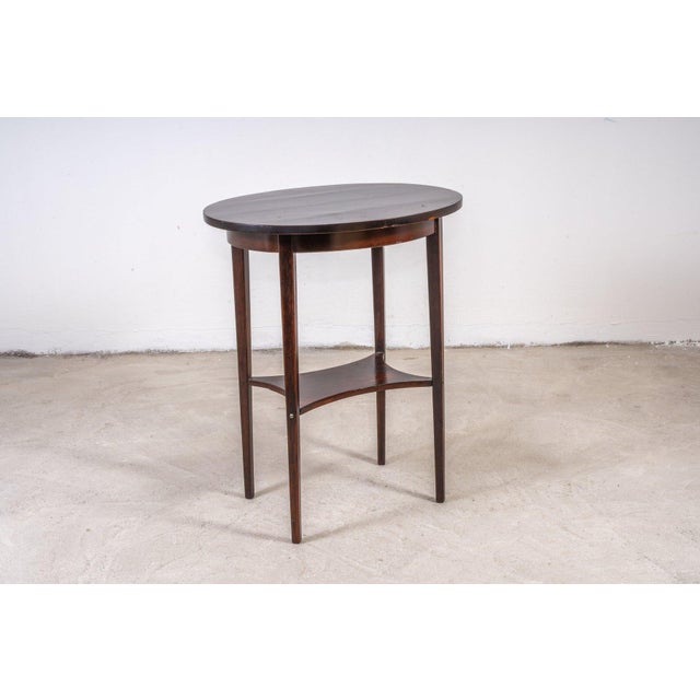 Timeless elegance to your space with this oval side table by Thonet, circa 1910 and attributed to Marcel Kammerer....