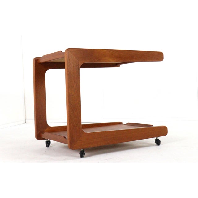 This beautiful mid-century modern tea trolley exudes timeless elegance. Crafted from warm teak, this model stands out with...