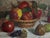 This painting is a classic still life featuring a woven basket filled with vibrant apples, surrounded by pears and...