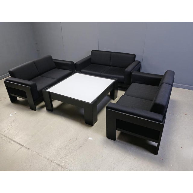 Mid century black fabric and ebonized wood frame 'bastiano' sofa set designed by Tobia Scarpa and produced by Knoll. The...