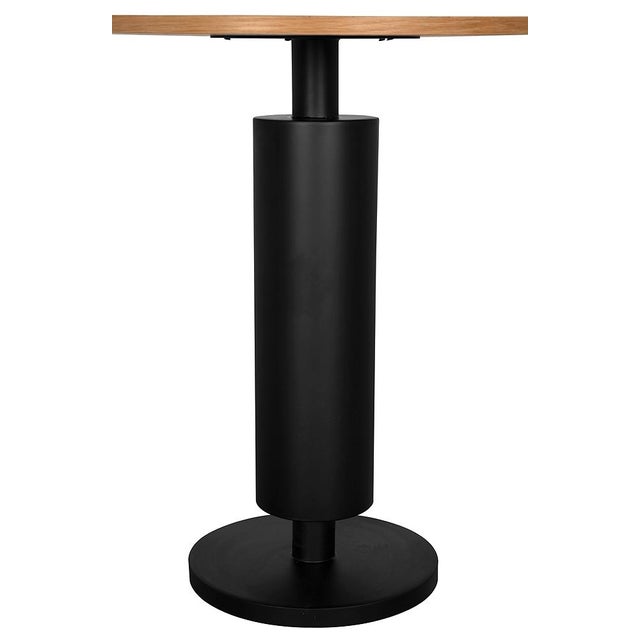 This sculptural side table features a round white oak top, supported by a cylindrical pedestal that rests on a circular...