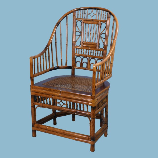 A handsome pair of highback Brighton Pavilion armchairs crafted from dark-stained bamboo with intricate spindle fretwork....