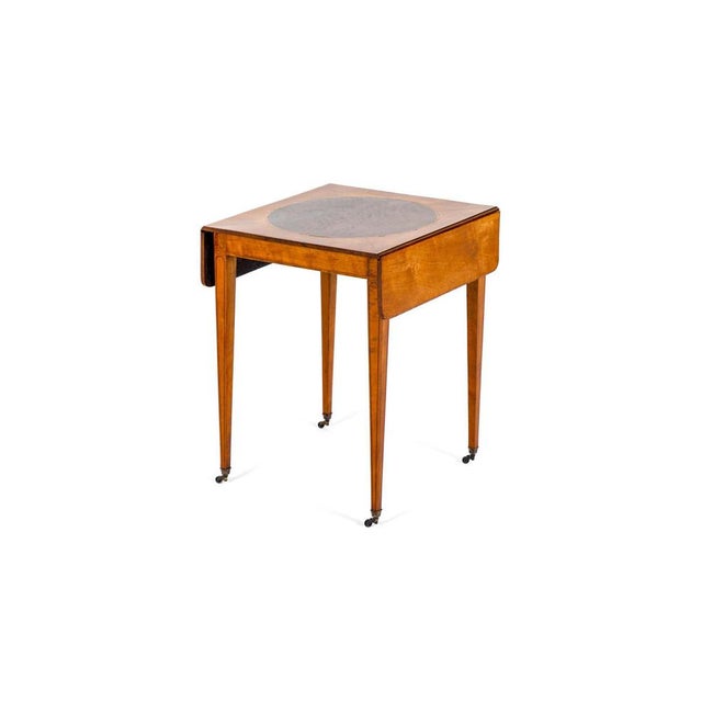 An exceptional satinwood and mahogany figured pembroke table of small and low proportions. The crossbanded rounded...