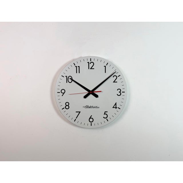 Industrial wall clock was produced by Elektročas in Czech republic during the 1990s. It features a white plastic dial and...