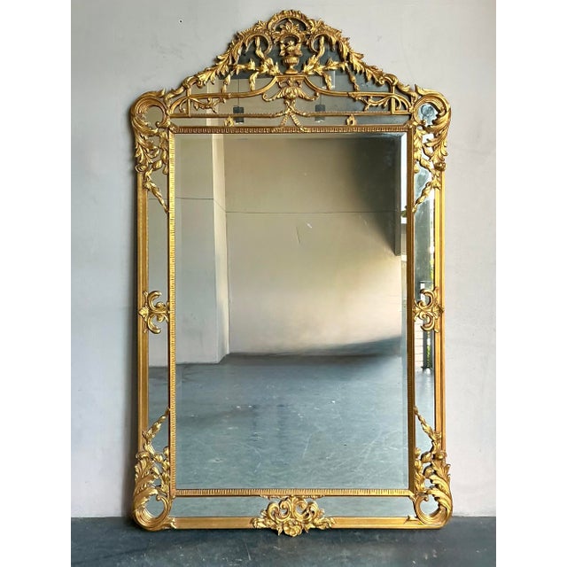 This breathtaking, floor-length mirror is a dramatic testament to the opulence of Hollywood Regency and Traditional...