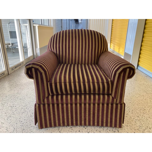 A very nice and well-made rolled arm club chair in burgundy and gold corduroy fabric. Dating from 2002 and retaining the...