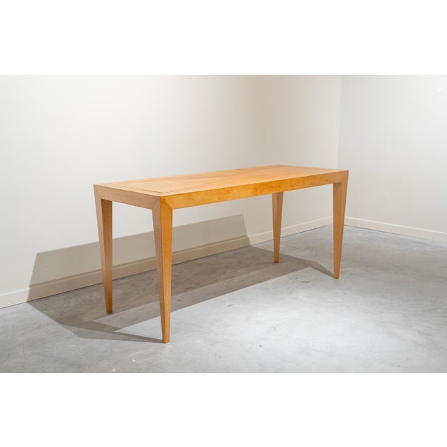 Narrow rectangular table that can serve as a console, desk, or dining table, made of honey-colored wood. Diamond-shaped...