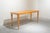 Narrow rectangular table that can serve as a console, desk, or dining table, made of honey-colored wood. Diamond-shaped...