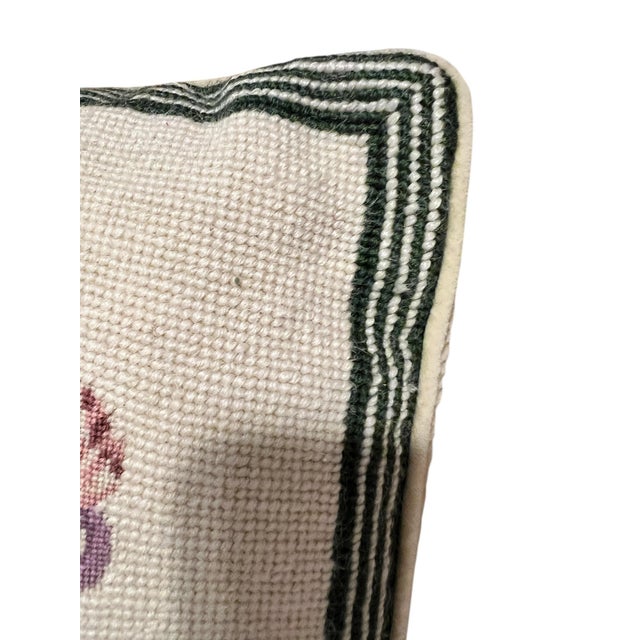 Vintage needlepoint petite point floral decorative pillow. The design features a needlepoint background in ivory with a...