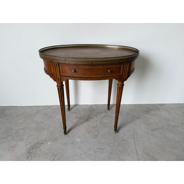 Elegant vintage accent table by Baker Furniture’s Milling Road collection featuring a classic Hollywood Regency design...