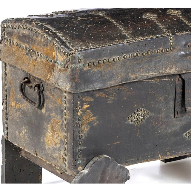 Chest. Portuguese style, made of wood; covered in leather with iron hardware; interior lined with chintz fabric and traces...