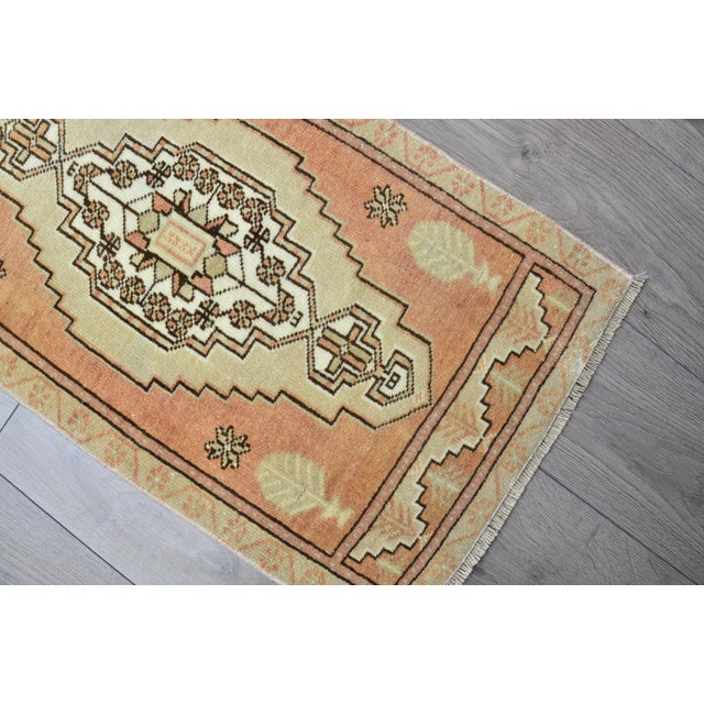 This is a vintage Turkish Oushak rug from the 1960s. The piece was hand-knotted.