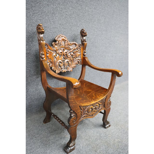 Victorian Quarter Sawn Oak Savonarola chair with claw feet and carved dragon design.