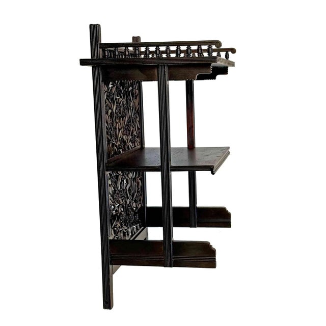 Antique late 19th century Aesthetic Movement wall shelf. Hand carved vine and foliate design.