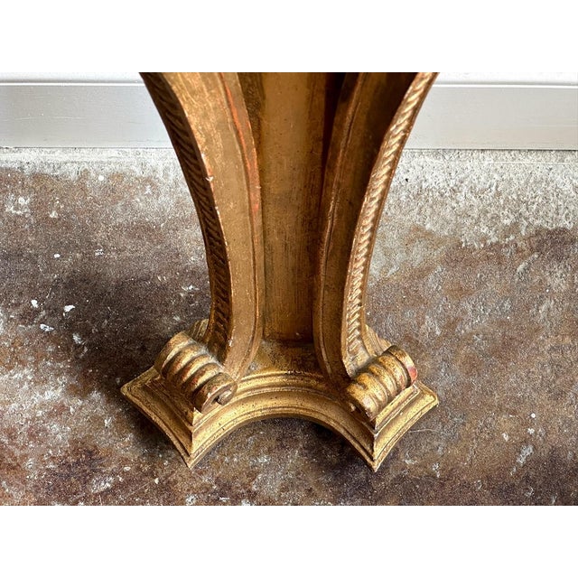 This vintage Florentine console is designed to hang on a wall. It is painted gold, with hand-carved detailing throughout,...