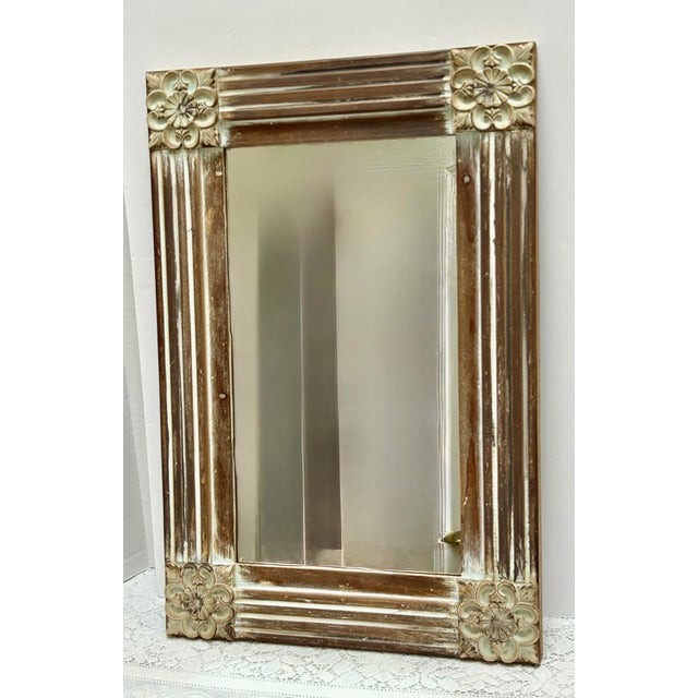 Vintage carved wood textural wall accent mirror with textured flowers on the corners and grooves in the wood pattern...