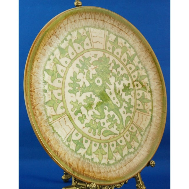 Item : A magnificent large glazed majolica plate, entirely hand-decorated with geometric patterns and a central rampant...
