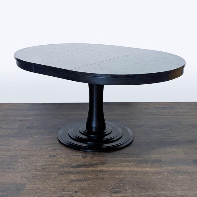 Pedestal base table that is 45 inches and extends to 60 inches with leaf. Brand: Crate and Barrel. Dimensions (in): 60W x...