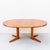 Vintage mid century modern expandable teak dining table on split pedestal base in newly refinished condition. The solid...