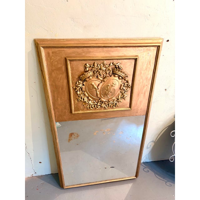 Beautiful vintage French Louis XVI–style trumeau mirror featuring a warm giltwood finish and an impressive raised heraldic...