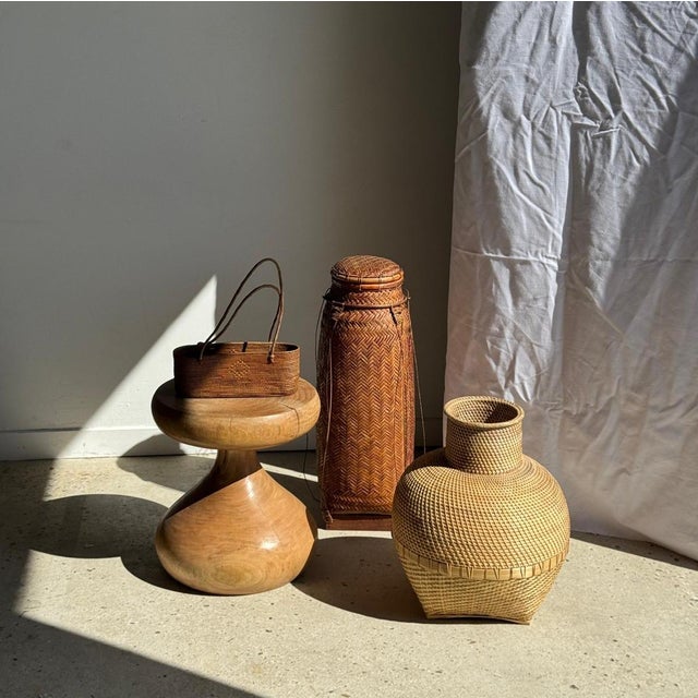Large traditional woven basket, cylindrical in shape with a slightly flared tip, fitted with a lid. The structure is made...