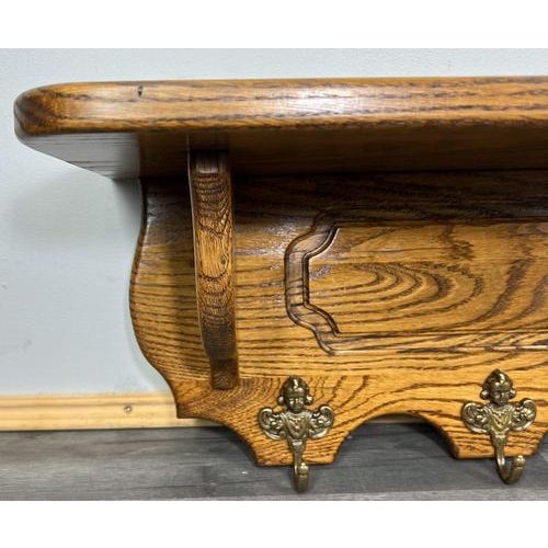 This elegant Vintage French coat hanger wall shelf features a beautifully shaped wood form with a wide upper shelf and...