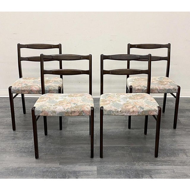 A set of 4 mid-century modern dining chairs in solid wood. The chairs are well made and functional and are upholstered in...