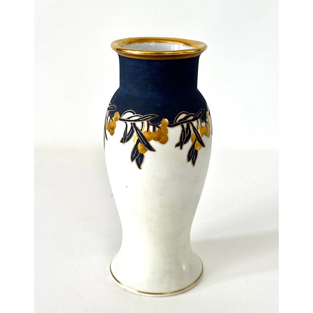 Lovely early 20th century porcelain vase made in Germany in a classic fishtail form. Matte white glaze and dark blue matte...