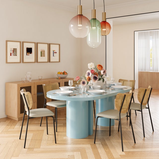 The Elora Lacquer Oval Dining Table is a stunning centerpiece for modern dining spaces, featuring a sleek lacquer finish...