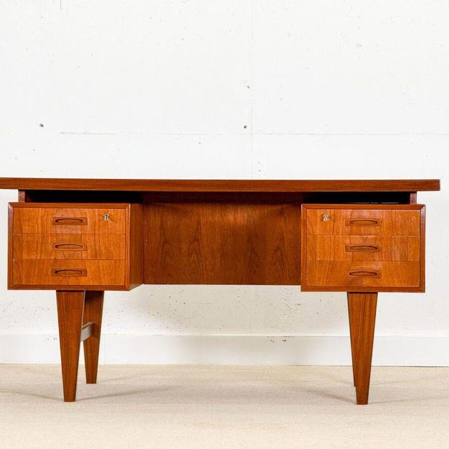 A striking mid-century Danish writing desk , designed and handcrafted in Denmark during the 1960s in richly grained dark...