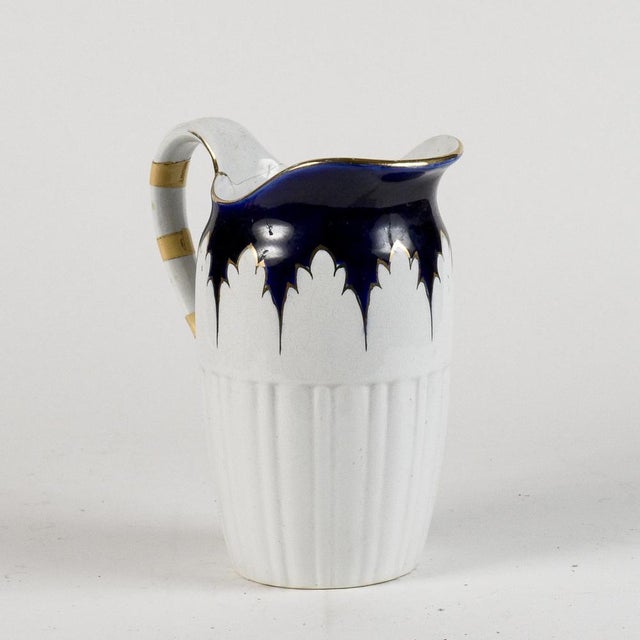 Ceramic jug with gold and blue decorations marked s.c. Richard 20th century the handle of the jug has some cracks with the...