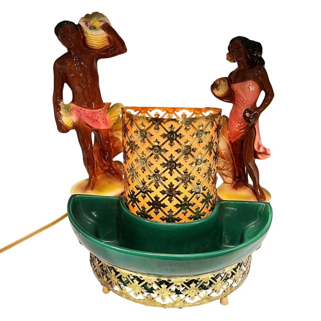 A rare mid-century Hollywood Regency style TV lamp with a gold-tone casted screen and a green pottery planter. The design...