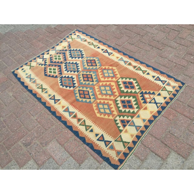 A beautiful vintage handwoven diamond design kilim. The kilim approximately 60 years old. It is handmade, of very fine...