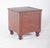 Antique wooden bedside table. with a simple structure and hinged lid, when opened it reveals a circular cut-out in the...