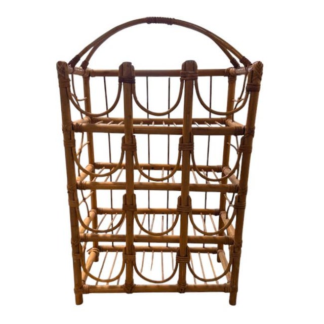 Vintage bamboo and rattan wine rack featuring an arched top, intricate wrapped joints, and sculptural curved bottle...