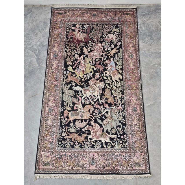 Beautiful silk rug hand knotted on silk. It depicts a hunting scene including human figures and animals. Made in Kashmir...