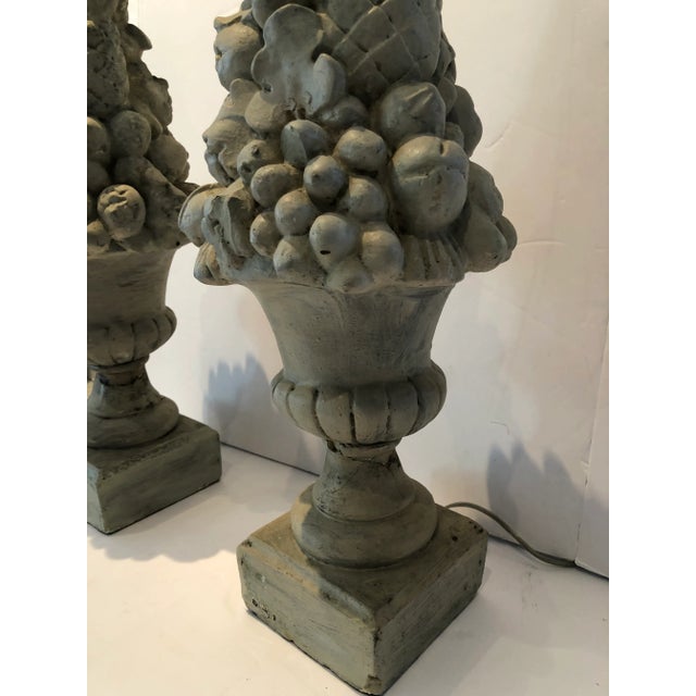 A charming pair of plaster topiary table lamps in a soft shade of grey.