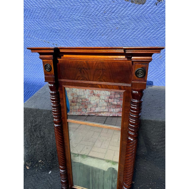 1940s Federal featuring a rectangular mahogany frame with ribbed pilasters on either side. The lower section is a new...